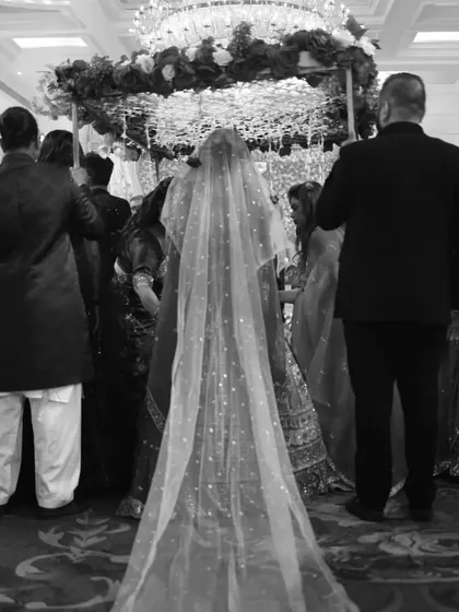 A timeless black and white shot of the bride's processional, capturing the emotion and anticipation of the moment she walks down the aisle.
