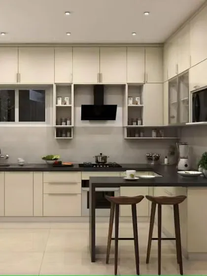 A simple and elegant peninsula extends from the main counter to form a breakfast bar in this L-shaped kitchen. The all-white cabinetry and dark countertop create a timeless and clean aesthetic.