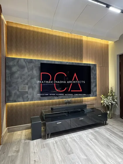 The TV panel in the son's room, featuring a combination of louvered wood and a stone-patterned surface, with backlighting to create a warm ambiance.