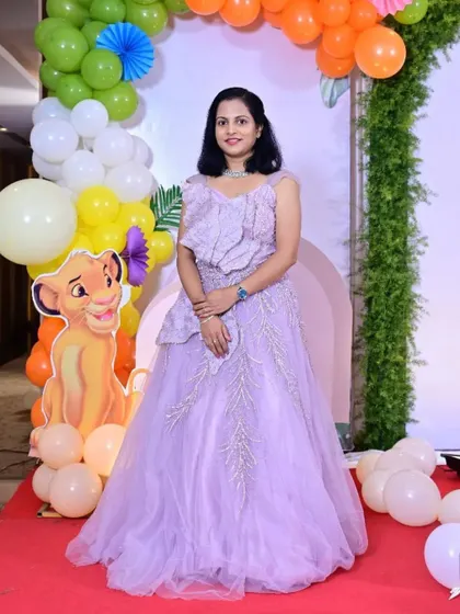 A happy client celebrating her child's birthday in my lavender gown. This dress features beautiful 3D floral and leaf embroidery on the bodice and skirt.