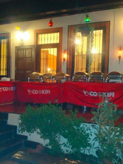 An evening buffet setup on a decorated porch, creating a wonderful ambiance for a house party.