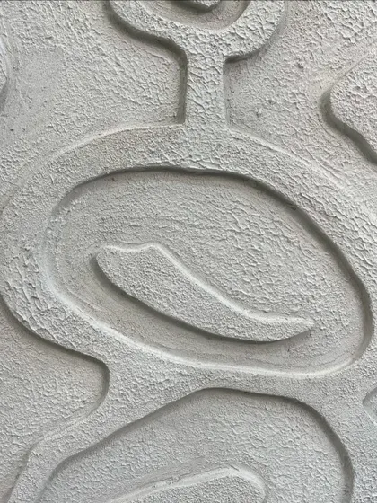 A detailed close-up of a white textured piece for a client in Hyderabad. The design features soft, interlocking lines and a rough, stone-like surface finish.
