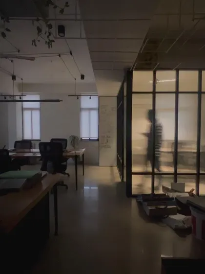 The interplay of light and shadow in our unfinished office space, creating a moody and atmospheric scene.