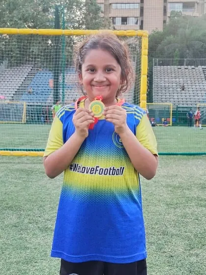 This young girl's smile shows the pride of being named Player of the Month.
