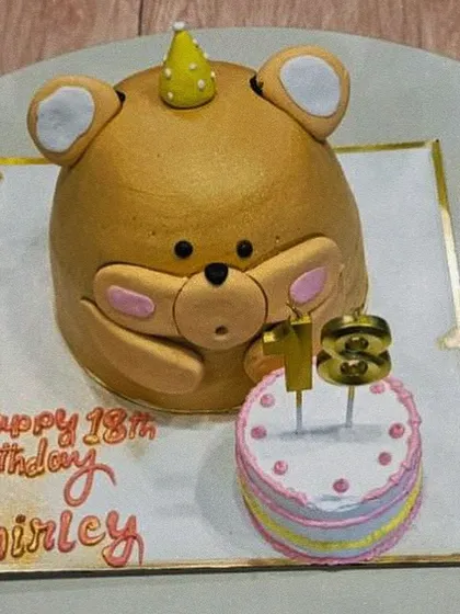 An adorable and creative teddy bear cake for an 18th birthday. This 3D sculpted cake shows our ability to create unique, character-based designs that stand out.