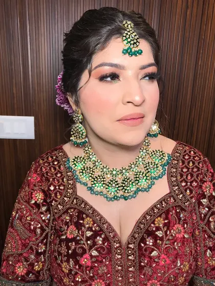Another angle, highlighting the floral details in her hair and the intricate embroidery of her blouse.