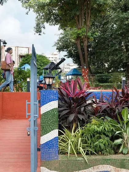 The entrance ramp at VDP Garden, featuring a wave pattern in china mosaic. This accessible entrance and the low, see-through railing improve both safety and visual connection to the street.