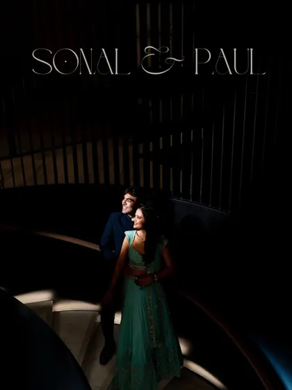 A dramatic, moody portrait of Sonal and Paul on the spiral staircase. We love using architectural elements and creative lighting to create unforgettable engagement shots.