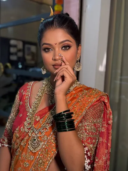 This is a classic Maharashtrian bridal look, complete with the traditional nath and chandrakor bindi. I love working with cultural elements to create an authentic and regal look that honors your heritage.