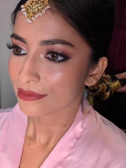 A behind-the-scenes shot of Afrin's makeup application, focusing on creating that signature glowing skin and soft, romantic eye makeup.