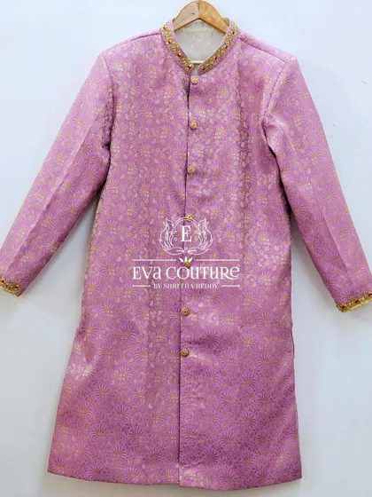 A simple and elegant men's sherwani in a lavender Banarasi silk. The collar and cuffs are detailed with fine gold embroidery.