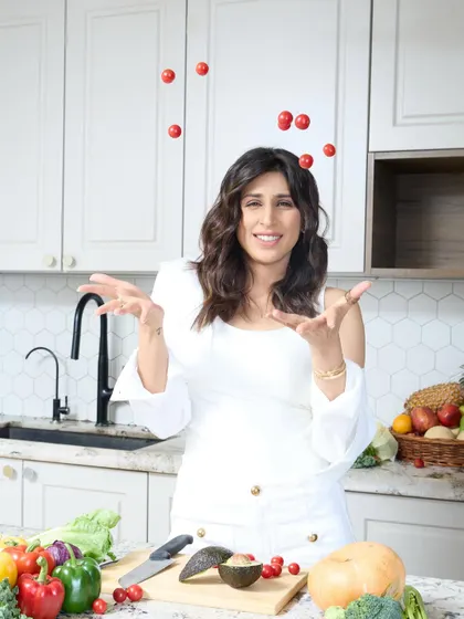 A playful and dynamic shot of Dietitian Nicole juggling tomatoes, adding a touch of fun and personality to her professional portraits.