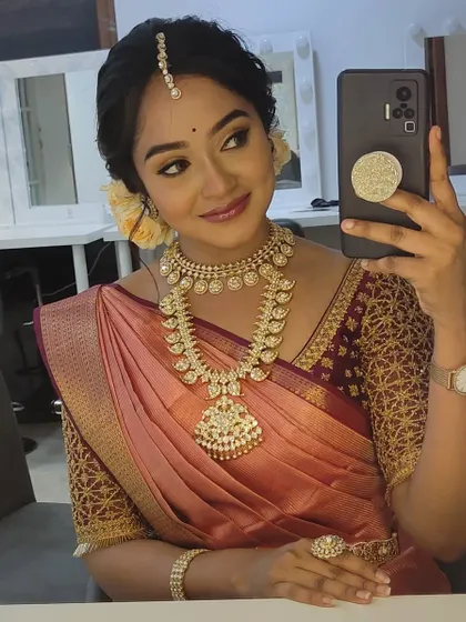 A behind-the-scenes selfie from the actress, giving a closer look at her makeup, jewelry, and the intricate blouse I designed.