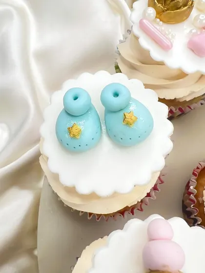 Tiny blue baby booties with little gold stars. Every topper is made with love and attention to detail for your baby shower.