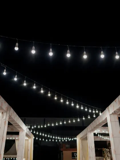 Strings of lights crisscrossing in the night sky, a simple yet highly effective way to create a magical atmosphere.
