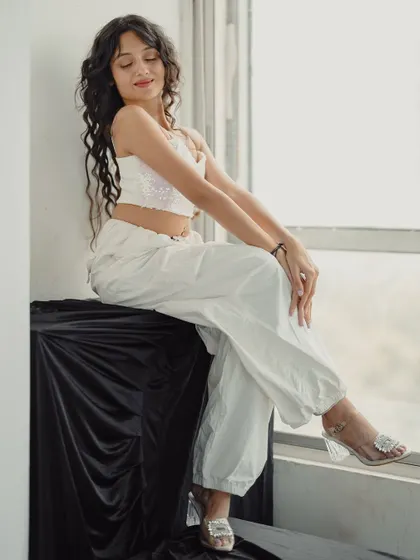 A full-length shot from a studio session, sitting by the window. I love how lighting can completely change the mood of a photo.
