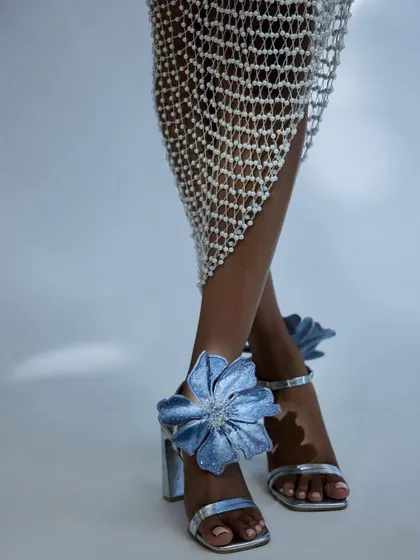 A detailed shot of 'The Bloom Heels' from the CAI Store x Kresha Bajaj collaboration. The focus is on the intricate floral design and texture of the shoe.
