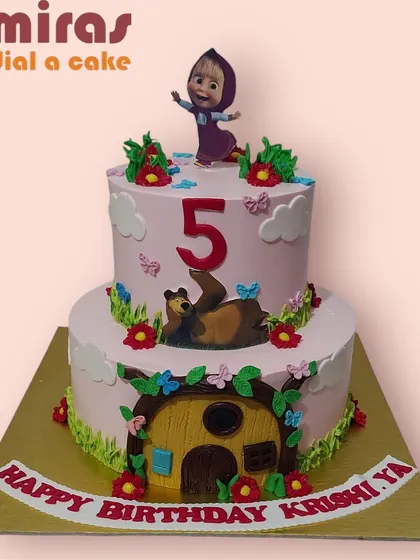 A delightful two-tier Masha and the Bear cake for a fifth birthday. The design shows Masha playing on top while the Bear relaxes by his cozy house on the bottom tier.