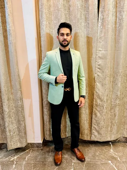 Dressed in a business casual blazer. I believe in achieving my dreams through dedication and hard work, and I bring that energy to my legal practice every day.