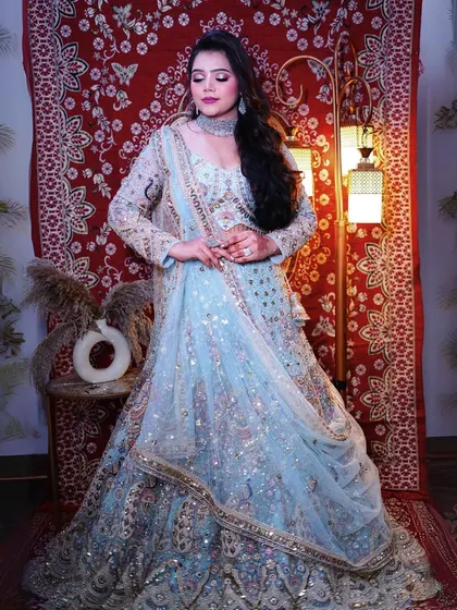 Another angle of our sky-blue peacock lehenga, showing how the light catches the sequin work beautifully.
