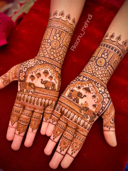 This bridal design celebrates tradition with prominent elephant motifs under ornate arches. The palms are filled with dense, fine-line patterns, creating a rich and festive appearance.