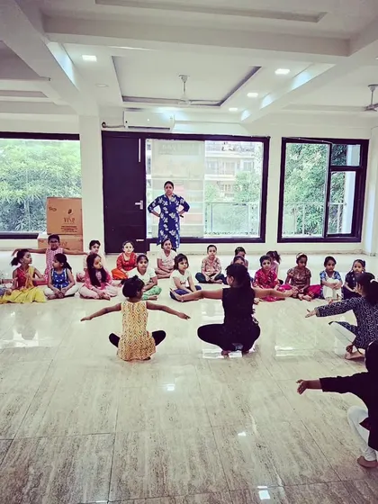 A wide view of our bright and spacious studio during a kids' Bharatanatyam class, with students learning from their instructor.