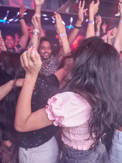 A view from inside the crowd, with everyone's hands in the air. This is what it feels like to be in the middle of one of my high-energy sets.