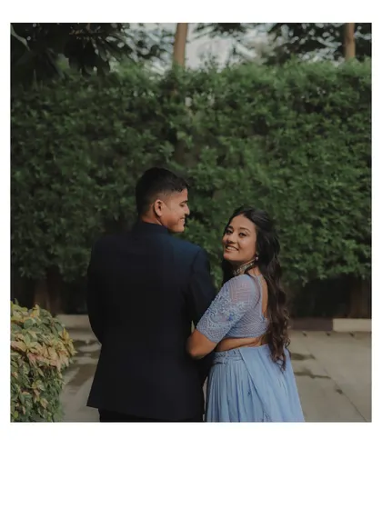 A playful 'look back' from the bride-to-be during their engagement walk. It's a charming and natural shot that captures her personality perfectly.