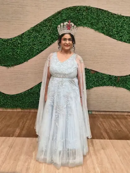 Our happy client, a pageant winner, looking stunning in our powder blue gown with a cape.
