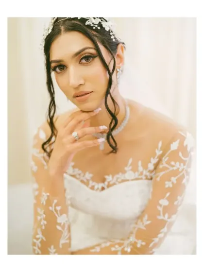 A stunning bridal portrait. The bride's elegant gown and serene pose are captured with a soft, artistic touch, highlighting her grace and beauty.