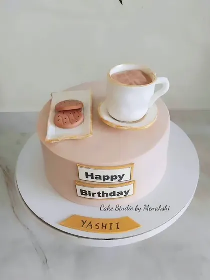 A simple and sweet cake for a tea lover. This design features a hand-crafted, edible teacup and saucer with a biscuit on the side.