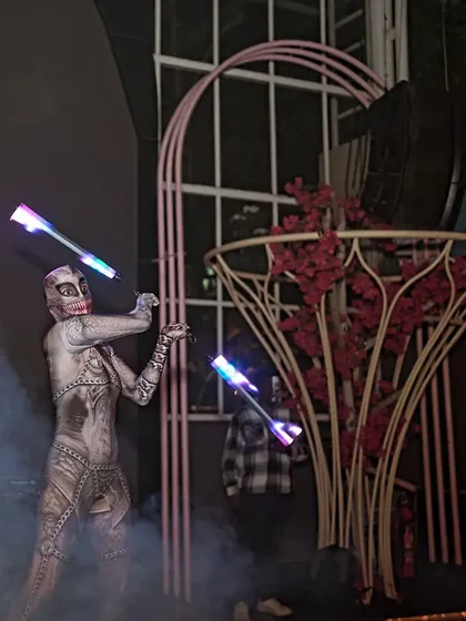 A smoky, atmospheric shot from a Halloween performance. The LED poi add to the spooky vibe, cutting through the fog with their eerie glow.