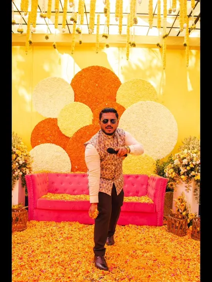 A dynamic action shot of me in my element during a Haldi ceremony.
