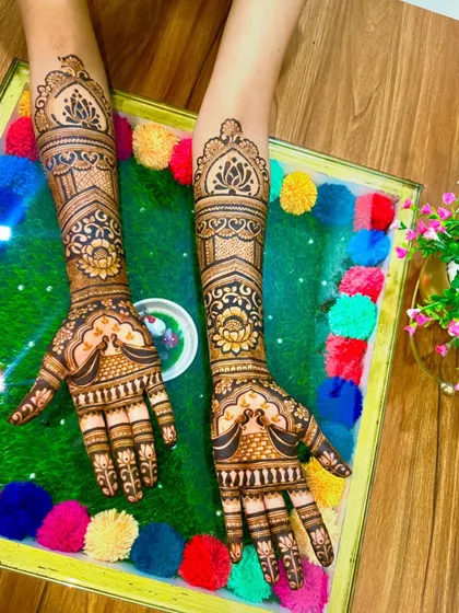 A clean and symmetrical design with peacock and lotus motifs, set against a colorful background.