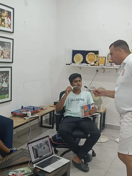 A coach interacts with a player during a mental training session, emphasizing the personalized approach we take to developing each athlete's mental fortitude.