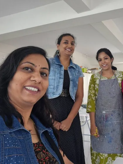 A group of friends posing for a photo after a fun and successful painting workshop.