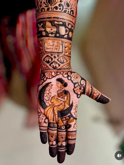 A creative baby shower mehandi showing a pregnant woman sitting on a crescent moon, with the question "Boy or Girl, what will baby be?" incorporated into the design.