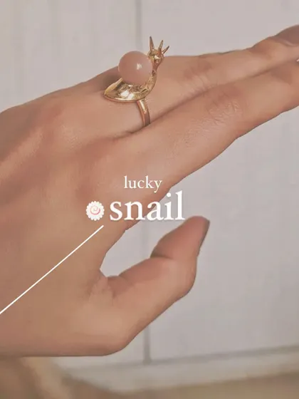 The lucky snail ring, crafted from Peach Moonstone.
