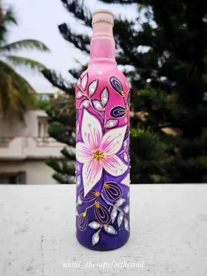 A closer look at the spontaneous floral bottle art. You can see the texture and the little details on the leaves and petals that make the design stand out.