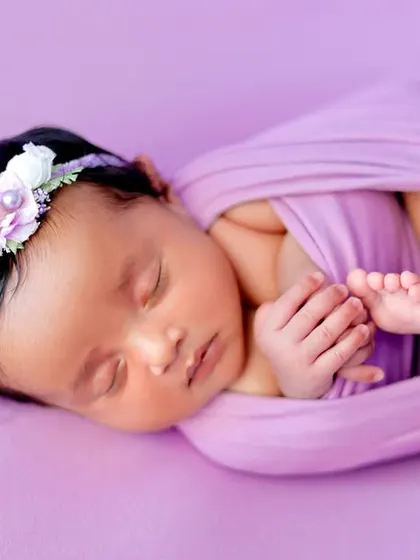 The potato sack pose, this time with a baby in a lavender wrap and a matching floral headband.