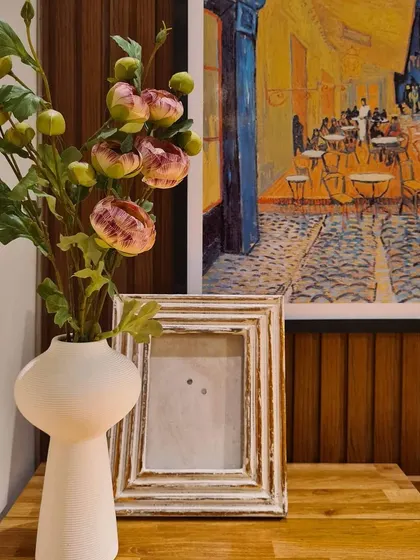 A close-up of the home office nook, showing how I used a simple palette of white, wood, and blue to tie the space together with the rest of the bedroom. The client's personal art makes the space feel unique.