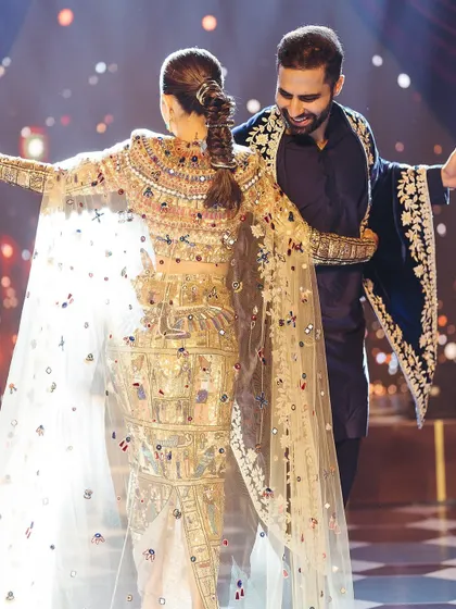 A beautiful moment from the couple's first dance, showcasing the intricate details of the bride's outfit and the pure happiness on their faces. We focus on creating choreography that allows for these picture perfect memories.