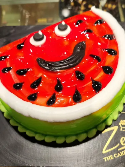 A slice of summer fun. This cake is cleverly designed to look exactly like a juicy slice of watermelon, complete with a smiling face.