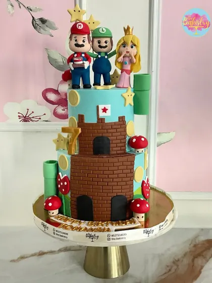 A Super Mario Bros. cake for a special 7th birthday. This two-tiered creation features a brick castle and the whole gang: Mario, Luigi, and Princess Peach.