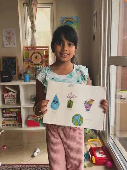 Another student showing her beautiful artwork inspired by our lesson on recycling and sustainability.