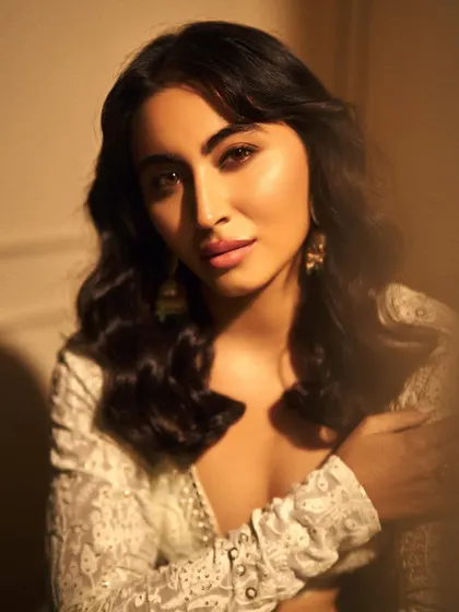 Absolutely stunning ethnic look on model Khatija Iqbal. The makeup is soft and luminous, with a focus on warm tones and a gentle pink lip to complement the intricate white outfit.