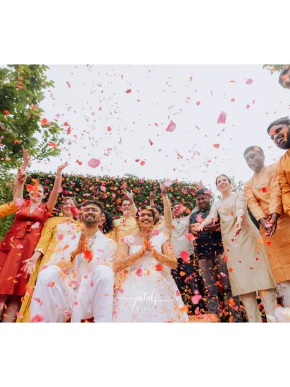 A low-angle shot of the petal shower, capturing the pure bliss and excitement of the moment.