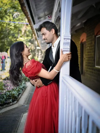 An intimate and romantic moment. The bride's red ball gown adds a touch of classic romance to this sweet couple's pre-wedding photo.