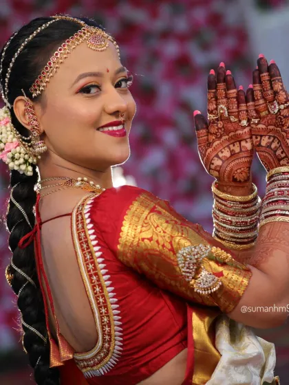 This pose highlights the beautiful henna work on the back of the hands and forearms. The design is a mix of bold traditional patterns and delicate details.