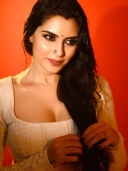 A slightly different angle, showing the texture of the hair and the subtle expression. The red background provides a consistent, bold theme.